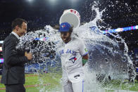 Toronto Blue Jays' Bo Bichette, right, is doused by teammate Vladimir Guerrero Jr. (not shown) after defeating the Kansas City Royals in a baseball game in Toronto, Friday, Sept. 8, 2023. (Nathan Denette/The Canadian Press via AP)