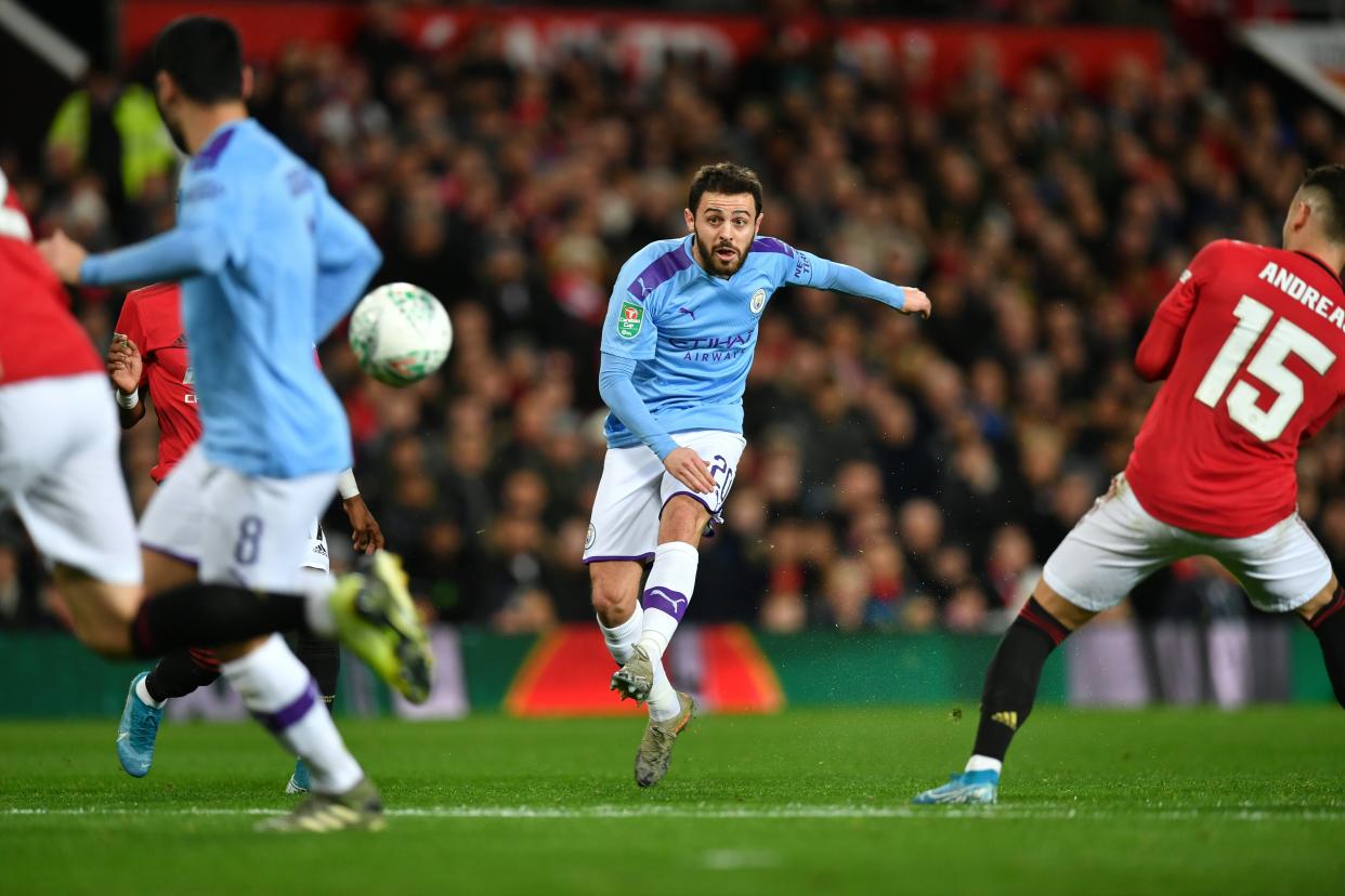 Manchester City's Portuguese midfielder Bernardo Silva (C) scores the opening goal during the English League Cup semi-final first leg football match between Manchester United and Manchester City at Old Trafford in Manchester, north west England on January 7, 2020. (Photo by Paul ELLIS / AFP) / RESTRICTED TO EDITORIAL USE. No use with unauthorized audio, video, data, fixture lists, club/league logos or 'live' services. Online in-match use limited to 75 images, no video emulation. No use in betting, games or single club/league/player publications. /  (Photo by PAUL ELLIS/AFP via Getty Images)