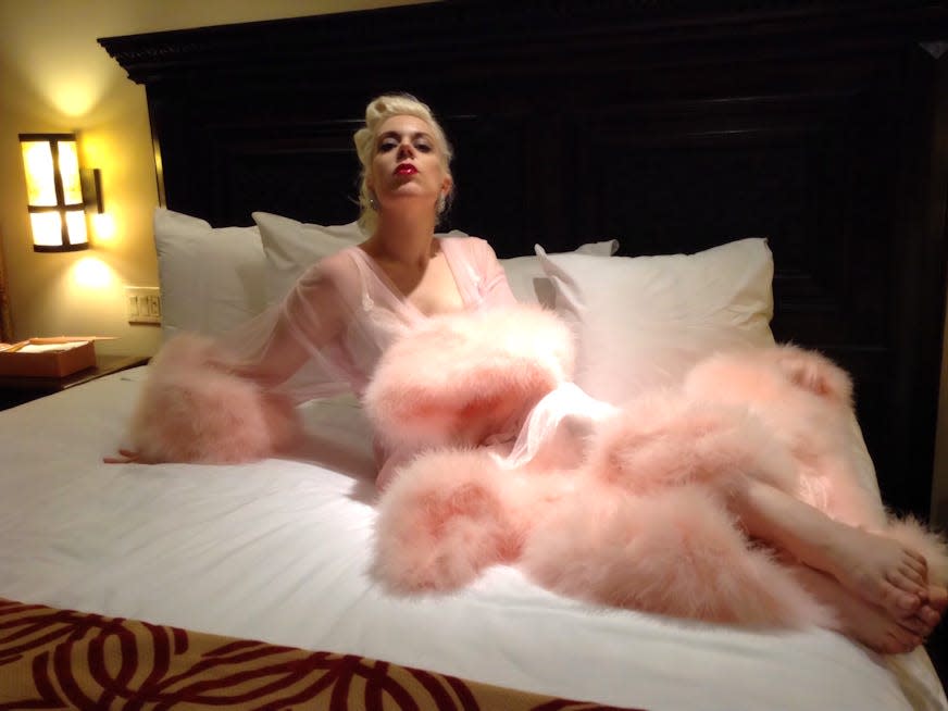 Photograph of Diamond Diva Princess wearing a pink old Hollywood style gown with fur