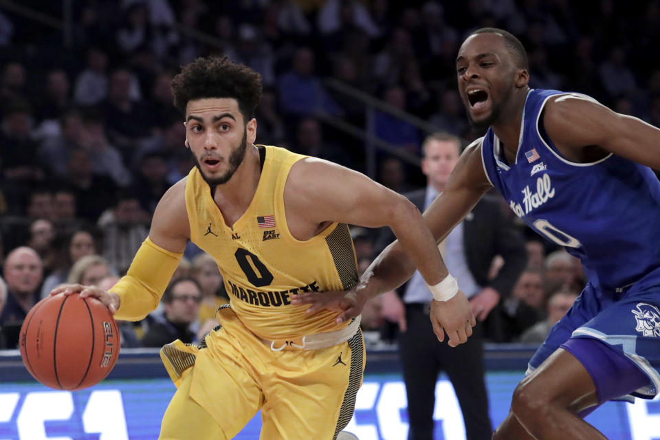 Marquette guard Markus Howard (0) drives against Seton Hall guard Quincy McKnight (0) during the first half of an NCAA college basketball semifinal game in the Big East men's tournament, Friday, March 15, 2019, in New York. (AP Photo/Julio Cortez)
