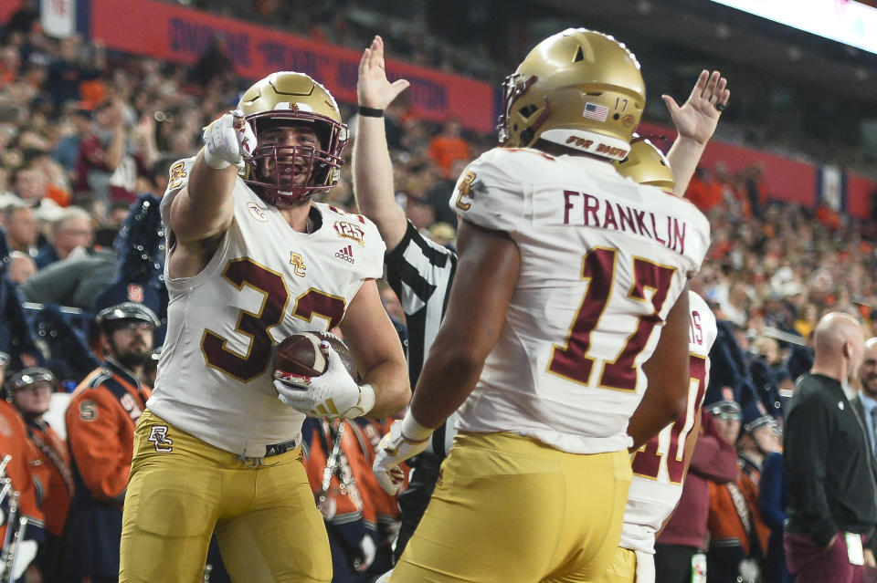 Boston College running back Anthony Ferrucci, left, celebrates with tight end Jeremiah Franklin (17) after scoring against Syracuse during the first half of an NCAA college football game in Syracuse, N.Y., Friday, Nov. 3, 2023. (AP Photo/Adrian Kraus)