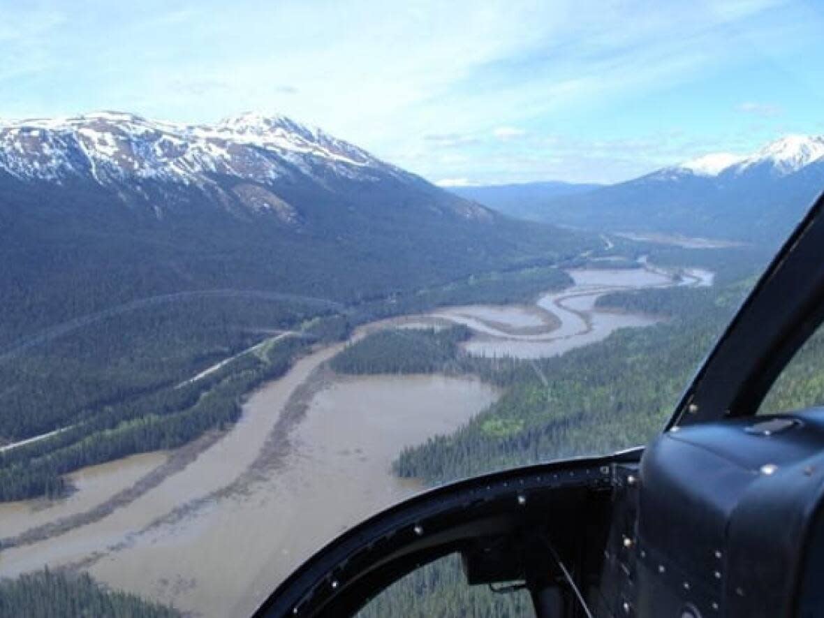 An aerial viewpoint shows the winding Dease River along Highway 37, north of the community of Dease Lake, about 1,750 kilometres northwest of Vancouver. The province has ordered jade mining operations in the region to stop. (TranBC/Flickr - image credit)