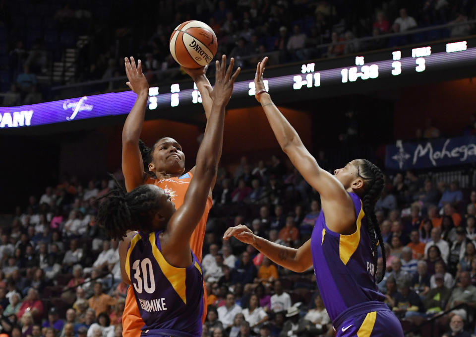 Connecticut Sun's Alyssa Thomas, center, shoots over Los Angeles Sparks' Nneka Ogwumike, left, and Los Angeles Sparks' Candace Parker right, during the first half of a WNBA basketball playoff game, Tuesday, Sept. 17, 2019, in Uncasville, Conn. (AP Photo/Jessica Hill)