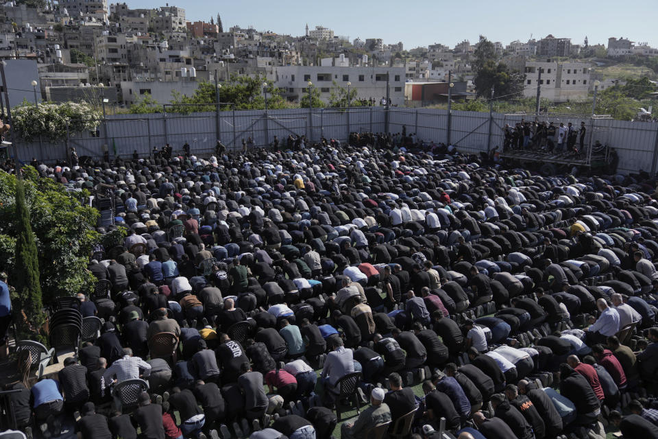 Mourners pray during the funeral of 13 Palestinians in the Nur Shams refugee camp near the West Bank town of Tulkarem, Sunday, April 21, 2024. The Palestinian Red Crescent rescue service said 14 bodies have been recovered from the Nur Shams urban refugee camp since an Israeli military operation began in the area Thursday night. The Islamic Jihad militant group confirmed the deaths of three members. Another killed was a 15-year-old boy. The Israeli army said its forces killed 10 militants in the camp and surrounding areas while eight suspects were arrested. (AP Photo/Majdi Mohammed)