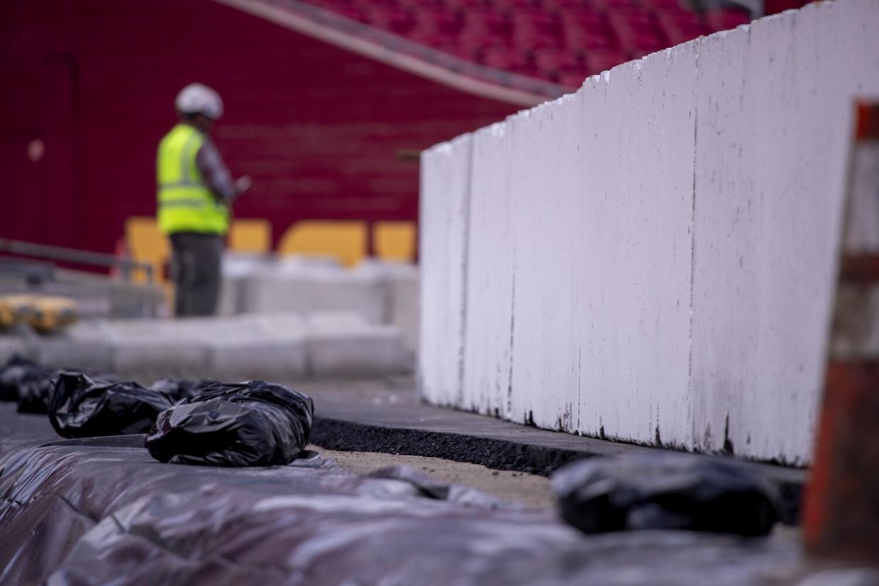 Construction crews transform the Coliseum from a football stadium to a quarter-mile short track NASCAR exhibition race track.