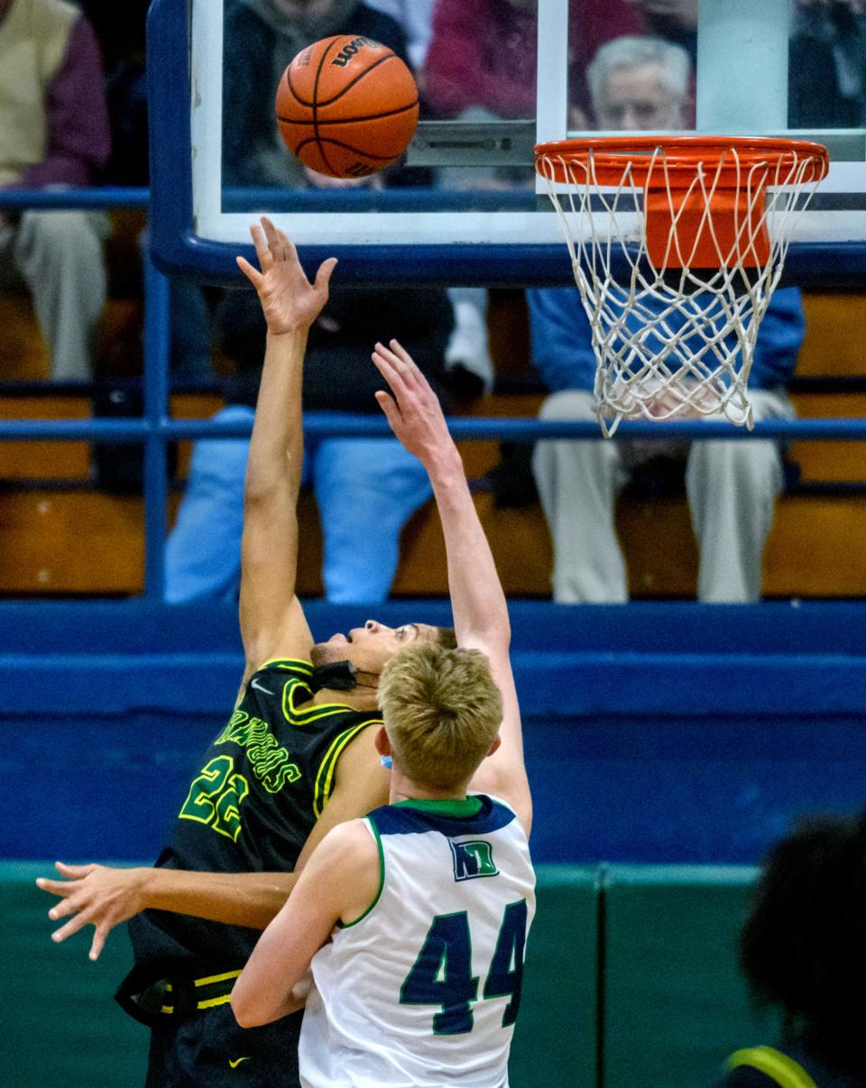 Richwoods' Jamauri Winfrey (22) puts up a shot past Peoria Notre Dame's Cooper Koch in the first half Friday, Dec. 3, 2021 at PND High School. The Knights defeated the Irish 52-45.