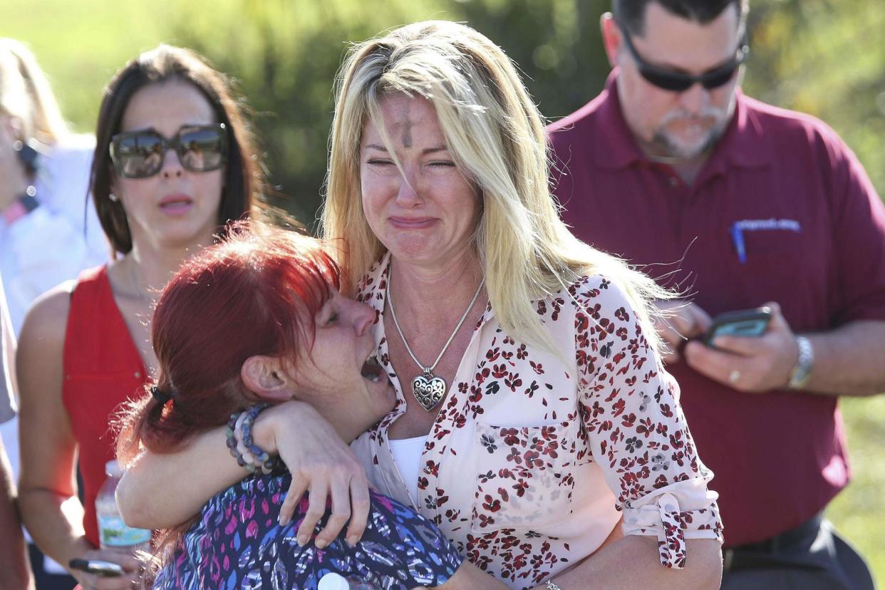 Parents wait for news after reports of a shooting at Marjory Stoneman Douglas High School in Parkland, Florida: AP