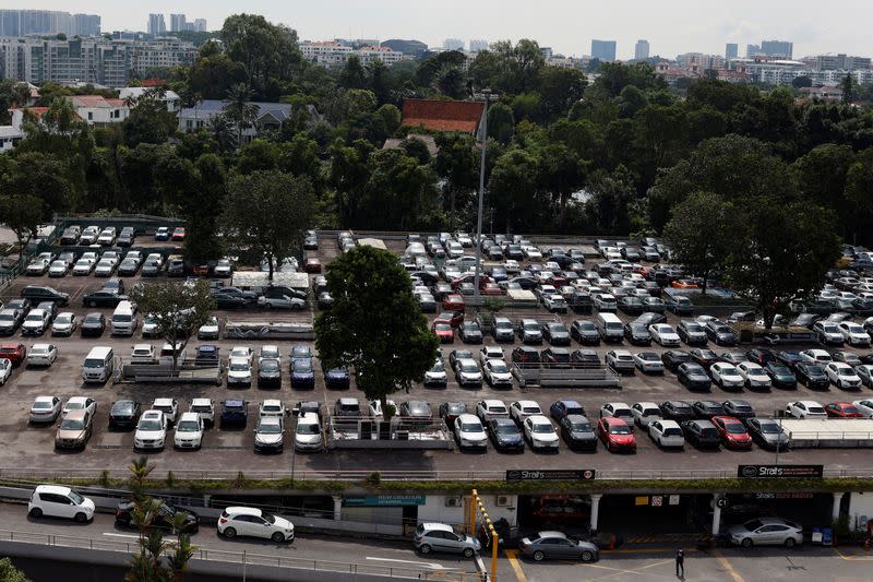 Cars for sale are parked at used car dealerships in Singapore