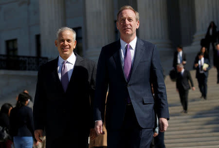 Microsoft President and Chief Legal Officer Brad Smith (R) and his lawyer Josh Rosenkranz make their way to the news media to make a statement outside of the U.S. Supreme Court in Washington, U.S., February 27, 2018. REUTERS/Leah Millis