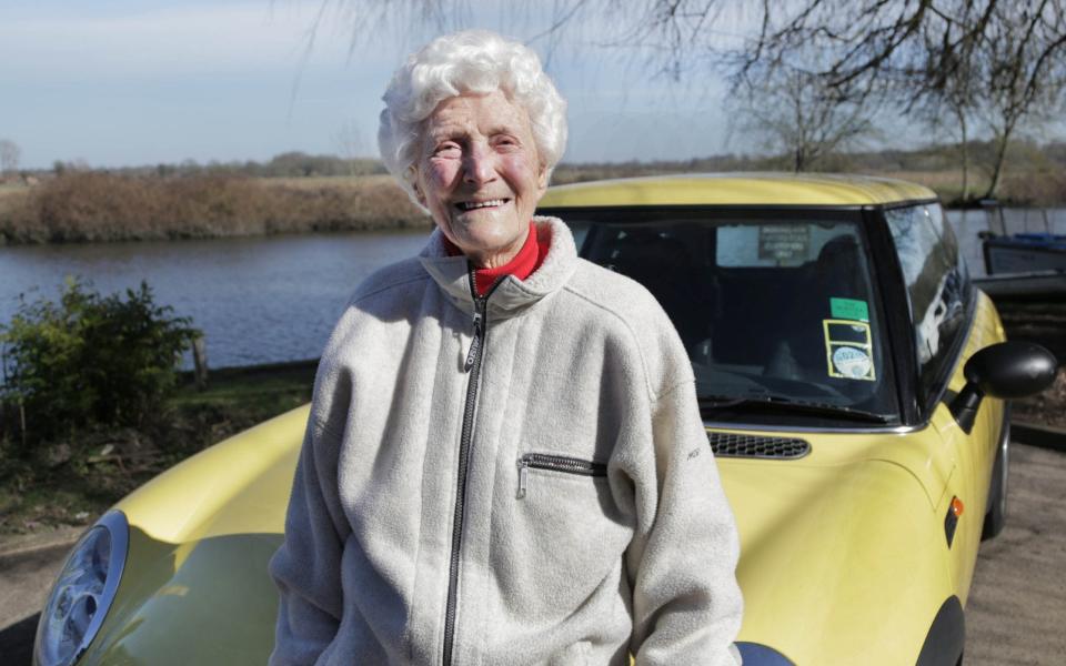 Eileen Ash with her yellow Mini Eileen is on of 8 people in the UK aged 105 years and still holding a driving licence '100 Year Old Driving School' TV Series - SHUTTERSTOCK