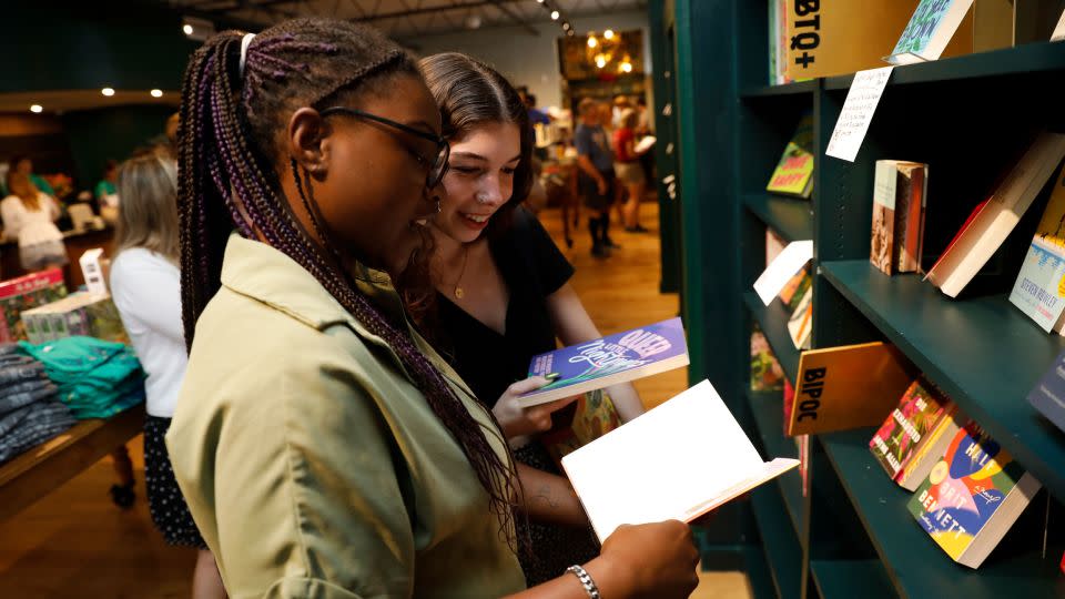 Palace Niekerk, left, and Emily Ayers browse through books by authors in the BIPOC and LGBTQ+ sections of the Lynx. - Octavio Jones for CNN