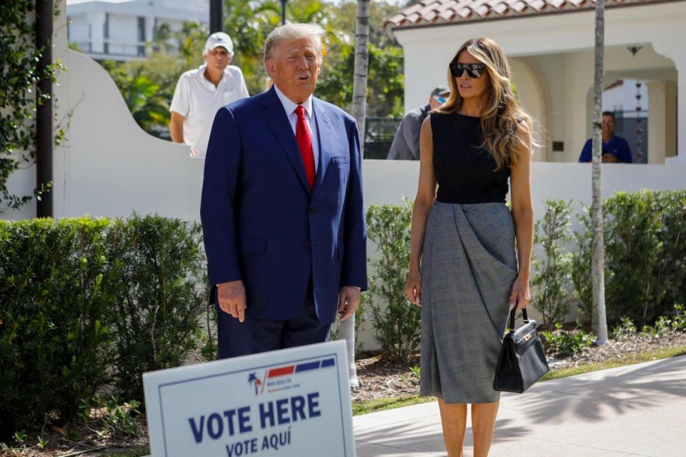 Donald and Melania Trump speak to the media while departing a polling station after voting in the US midterm elections (AFP via Getty Images)