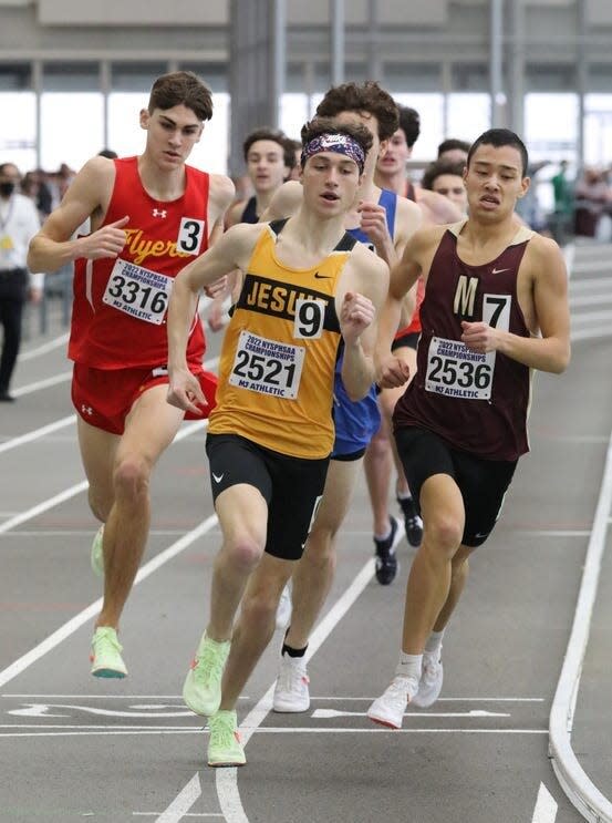 McQuaid senior Jayson Chichelli leading Pittsford Mendon's Nico Valentine and others during the boys 1,000-meter race at the high school indoor track state championships.