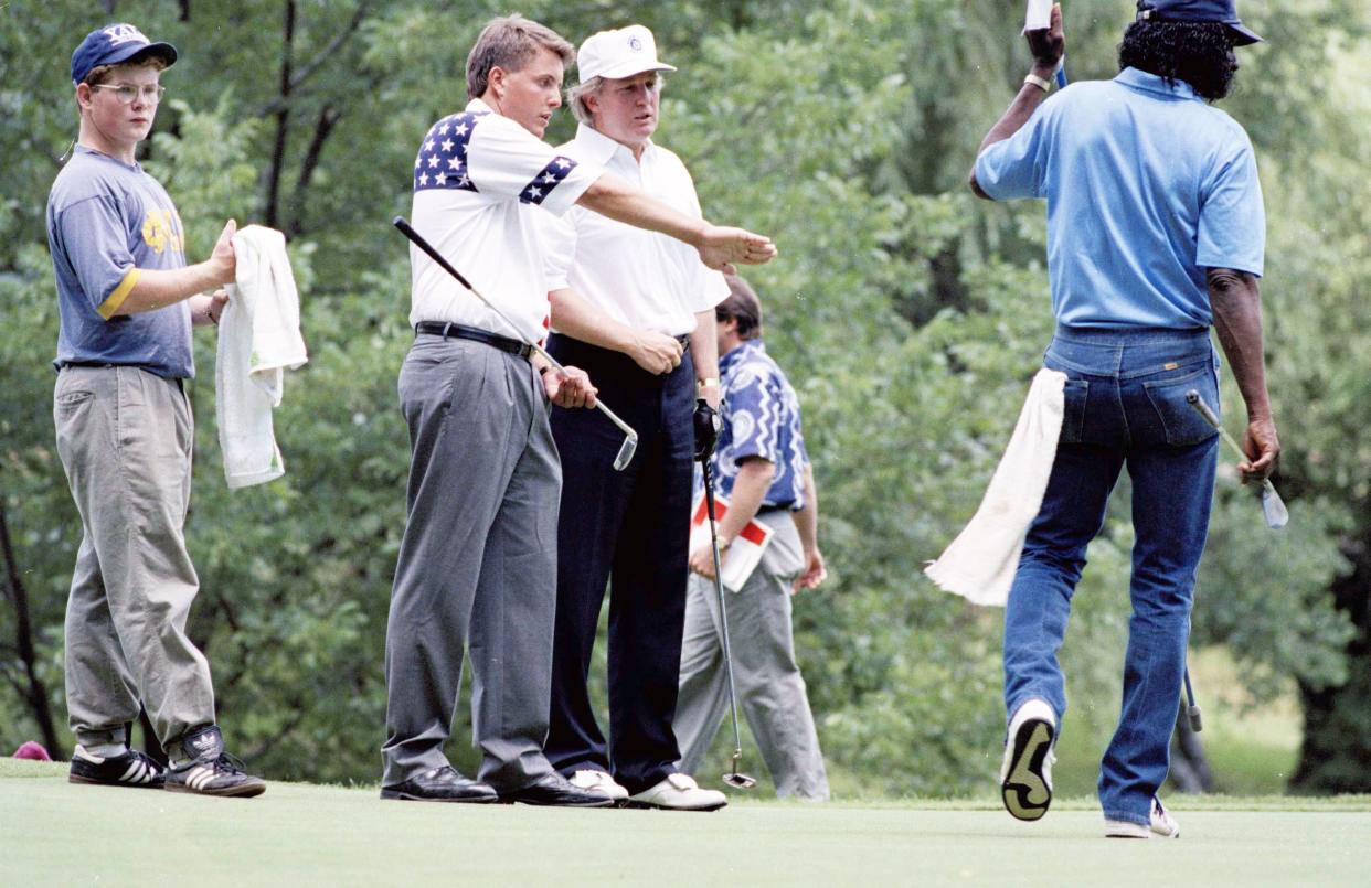 Donald Trump is shown the way around the Winged Foot Golf Club by Arizona State's Phil Michelson, left, U.S. amateur champion for the 1991 All-American Collegiate Golf team, in Mamaroneck, N.Y., on June 24, 1991.