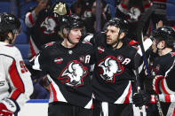 Buffalo Sabres left wing Zemgus Girgensons, center right, celebrates his goal with defenseman Rasmus Dahlin (26) during the first period of an NHL hockey game against the Washington Capitals Tuesday, April 2, 2024, in Buffalo, N.Y. (AP Photo/Jeffrey T. Barnes)