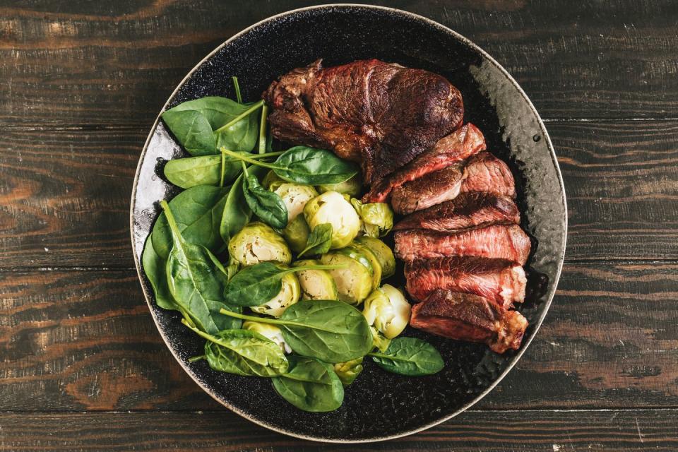 steak, brussels sprouts and spinach top view for good housekeeping's alpha lipoic acid benefits story