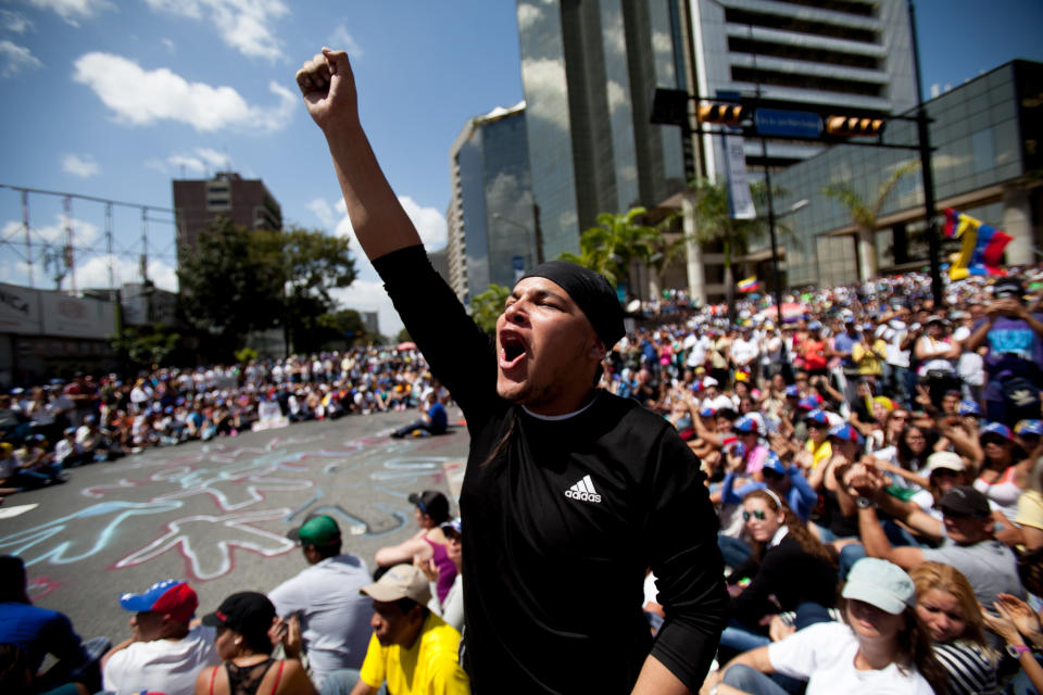 A demonstrator shouts slogans against Venezuela's President Nicolas Maduro during a protest asking for the disarmament of armed groups in Caracas, Venezuela, Sunday, Feb. 16, 2014. For the past several days, protests have rocked Caracas yielding several dead and scores of wounded in clashes between opposition protesters with security forces and pro-government supporters. (AP Photo/Alejandro Cegarra)