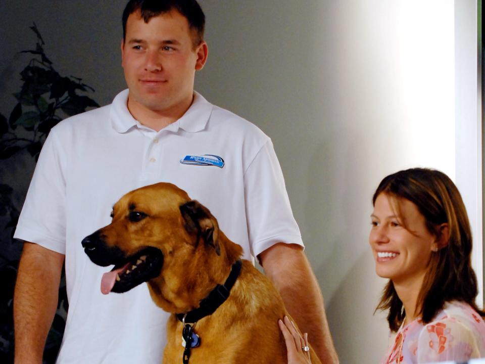 NASCAR driver Ryan Newman, left, is pictured with his wife wife Krissie, right, and dog Mopar during a news conference where the Ryan Newman Foundation announced the nationwide release of a book it published entitled Pit Road Pets at the Daytona International Speedway in Daytona Beach