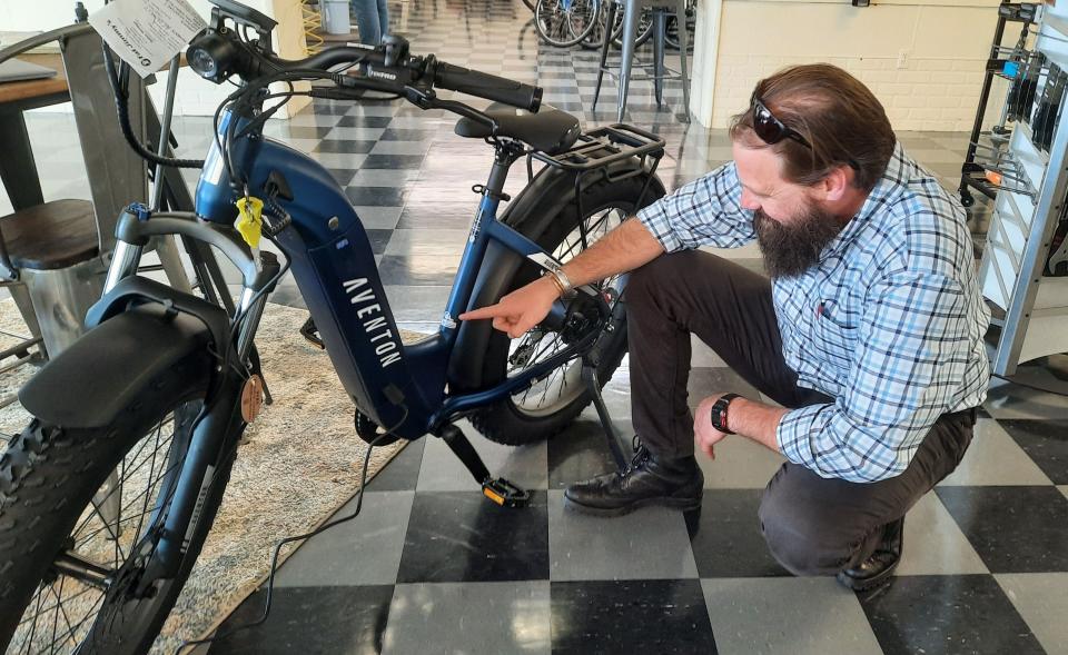 Pennsylvania's director of outdoor recreation, Nathan Reigner, checks out the latest e-biking technology, April 26, at  Fat Jimmy's Cycle and Fitness in Johnstown. He toured nine parts of Pennsylvania over the last month talking about growing outdoor recreational opportunities.