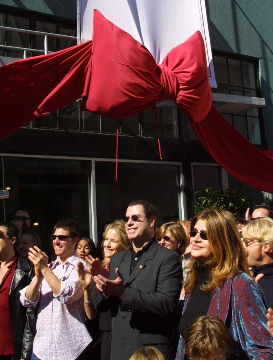 Actors Tom Cruise, Kelly Preston, John Travolta, and Kirstie Alley listen to Jenna Elfman speak at the opening of the Church of Scientology, Mission of SoMa (San Francisco), in September 2001. (Photo: Getty Images).