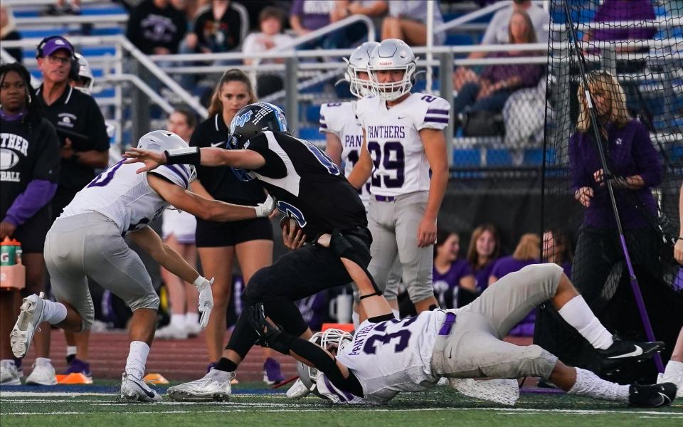 Bloomington South kicker Bryce Taylor (29) looks on as Duke Conrad (33) tackles Columbus North’s Asher Ratliff (15) during the football game at Columbus North on Friday, Sept. 29, 2023.