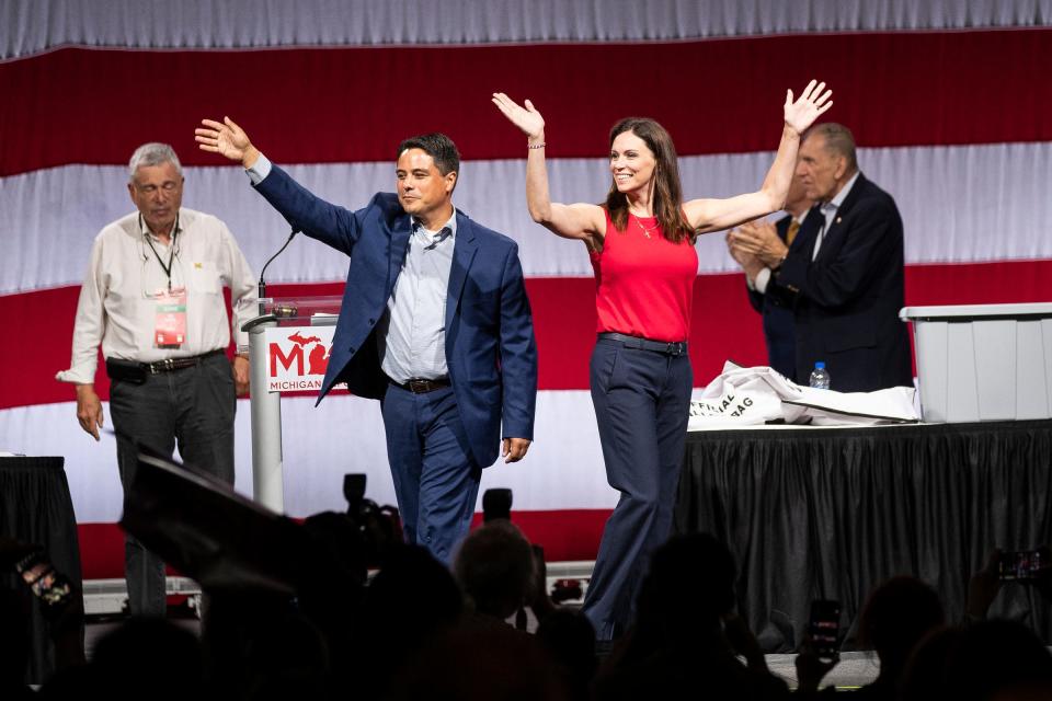 Gubernatorial candidate Tudor Dixon and Lt. Gov. candidate Shane Hernandez wave at supporters after delegate votes were being reported during the MIGOP State Nominating Convention at the Lansing Center in Lansing on Saturday, Aug. 27, 2022.