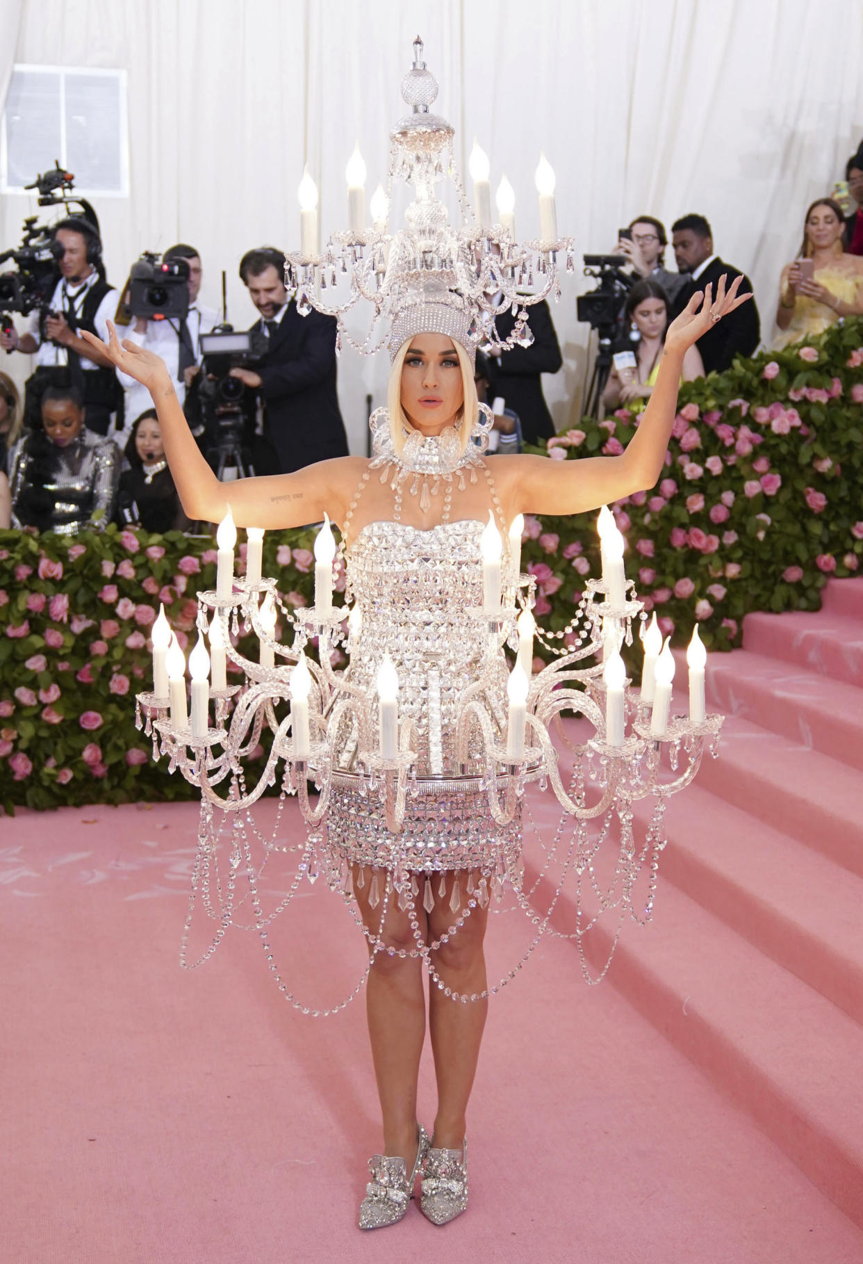 Katy Perry at the 2019 Costume Institute Benefit Gala celebrating the opening of “Camp: Notes on Fashion” wearing a chandelier mini dress by Moschino. - Credit: zz/Elaine Wells/STAR MAX/IPx