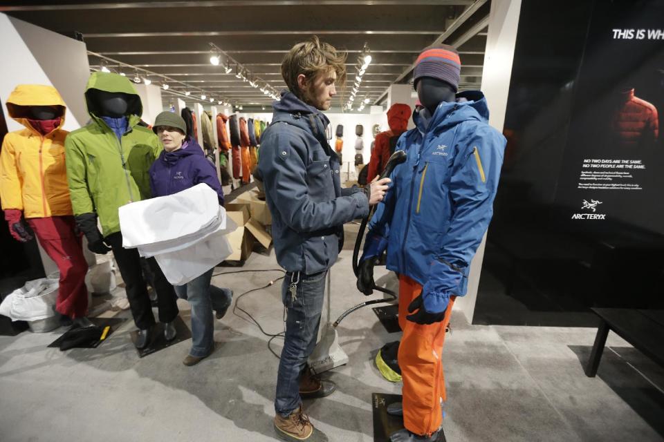 Prescott McCarthy, steams a jacket while setting up the Arcteryx display at the Outdoor Retailer show Tuesday, Jan. 22, 2013, in Salt Lake City. The Outdoor Retailer show, which kicks off this Wednesday at the Salt Palace Convention Center, draws more than 25,000 people and pours more than $40 million into Utah’s economy every year. One of the world's largest outdoor gear trade shows will remain in Salt Lake City at least through 2016. The shows were previously contracted to stay through 2014. (AP Photo/Rick Bowmer)