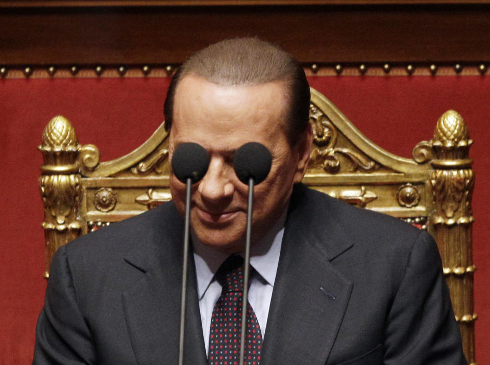 FILE - Italian Premier Silvio Berlusconi is framed by microphones prior to deliver his speech at the Italian Senate Sept. 30, 2010. Berlusconi, the boastful billionaire media mogul who was Italy's longest-serving premier despite scandals over his sex-fueled parties and allegations of corruption, died, according to Italian media. He was 86. (AP Photo/Alessandra Tarantino, File)