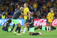 Nigeria's Onome Ebi, left, and Nigeria's Osinachi Ohale celebrate at the end of the Women's World Cup Group B soccer match between Australia and Nigeria In Brisbane, Australia, Thursday, July 27, 2023. Ohale scored once and Nigeria won 3-2. (AP Photo/Tertius Pickard)