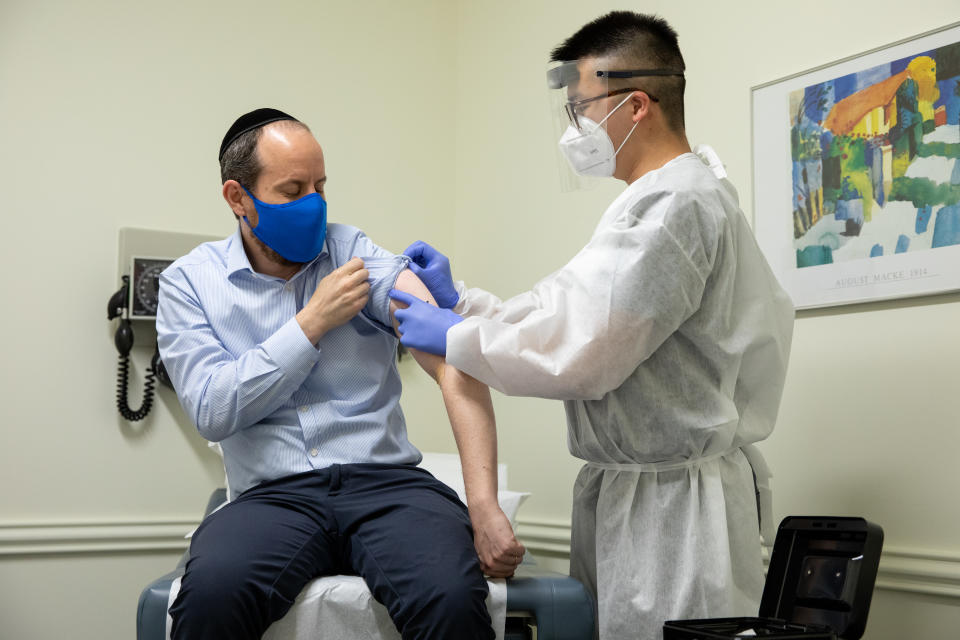 ROCKVILLE, MD - JULY 27: Rabbi Shmuel Herzfeld has his arm disinfected by Dr. Chao Wang during a clinical trial for a Coronavirus vaccine at Meridian Clinical Research in Rockville, Maryland on Monday, July 27, 2020. The Coronavirus vaccine was created by the biopharmaceutical company Moderna. (Photo by Amanda Andrade-Rhoades for The Washington Post via Getty Images)