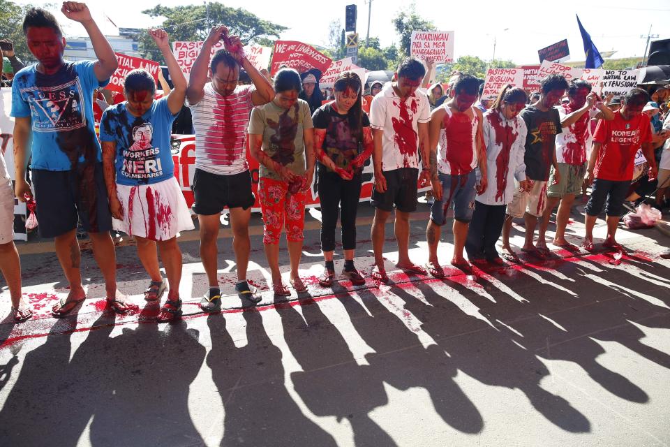 Protesters smear red dye on their faces to depict the alleged killings and human rights abuses under Martial Law in the south during a rally at the Lower House to coincide with the joint Senate and Congress vote for the third extension of Martial Law in southern Philippines Wednesday, Dec. 12, 2018 in suburban Quezon city northeast of Manila, Philippines. In their statement, various opposition groups condemned the extension of Martial Law which allegedly will “lead to untimely death of more community leaders, human rights defenders, Indigenous Peoples, and Muslim opposition groups.” (AP Photo/Bullit Marquez)