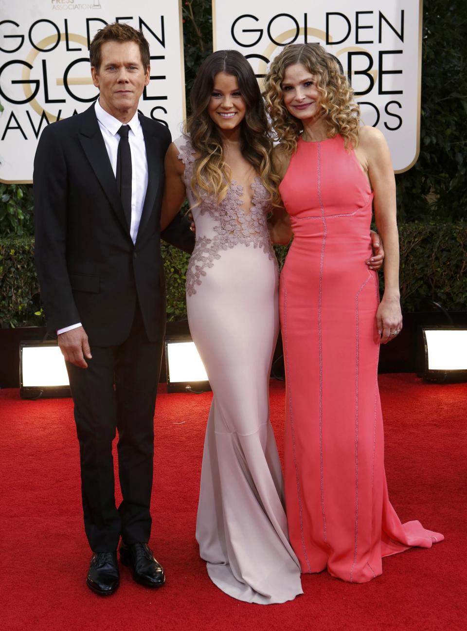 Actor Kevin Bacon with daughter Sosie Bacon and wife Kyra Sedgwick pose on arrival at the 71st annual Golden Globe Awards in Beverly Hills