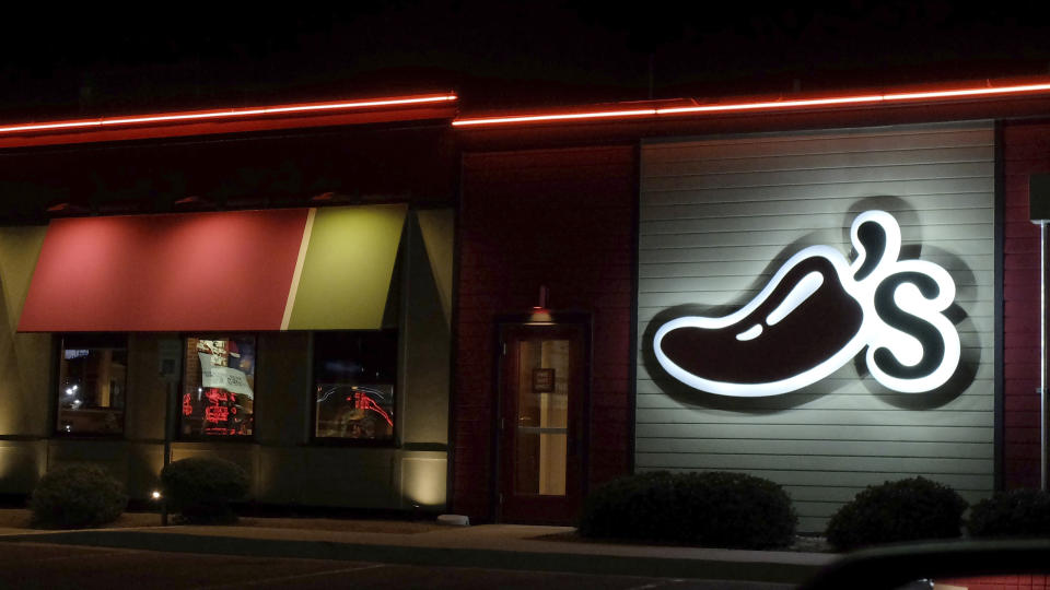 A Chili's restaurant logo stands lit in El Paso, Tex., Wednesday, Oct. 23, 2019. (AP Photo/Rogelio V. Solis)