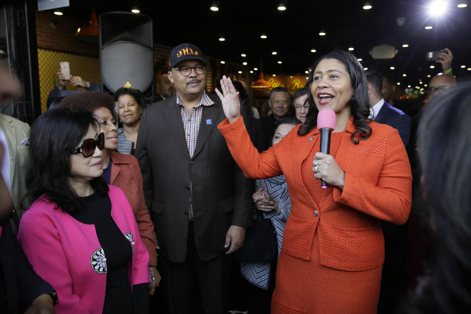 San Francisco Mayor London Breed, right, speaks during the opening of Lefty O'Doul's new 20,000 square foot Baseball Ballpark Buffet & Café at Fisherman's Wharf, as Anita Lee, left, widow of former Mayor Ed Lee, listens, Tuesday, Nov. 20, 2018, in San Francisco. The popular Union Square bar and restaurant Lefty O'Doul's closed in January 2017 due to a dispute between the owner and his landlord, but now the restaurant has returned on the wharf. Lefty O'Doul's was named after the well-known and respected New York Giants star outfielder. With a .398 batting average, he boasted the highest average out of any outfielder in the 20th century. (AP Photo/Eric Risberg)