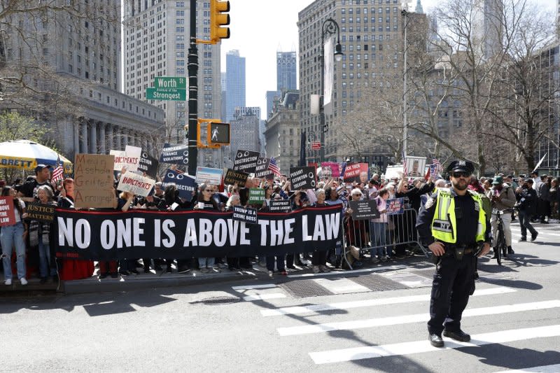 Media as well as Trump protesters and supporters of former President Donald Trump stand behind barricades while former President Donald Trump is at State Supreme Court at 100 Centre Street for his arraignment after a grand jury indictment in New York City on April 4. File Photo by John Angelillo/UPI