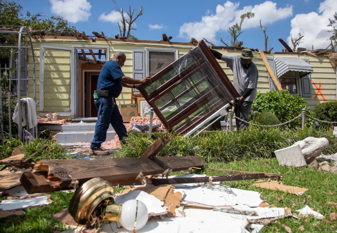 Family members help clean up the home of Evelyn Powell, an Edgecombe County Commissioner, Thursday, July 20, 2023 in Battleboro. An EF3, tornado with wind speeds of 150 mph touched down in Nash and Edgecombe Counties around 12:30 p.m. Wednesday according to the Raleigh National Weather Service. Travis Long/tlong@newsobserver.com