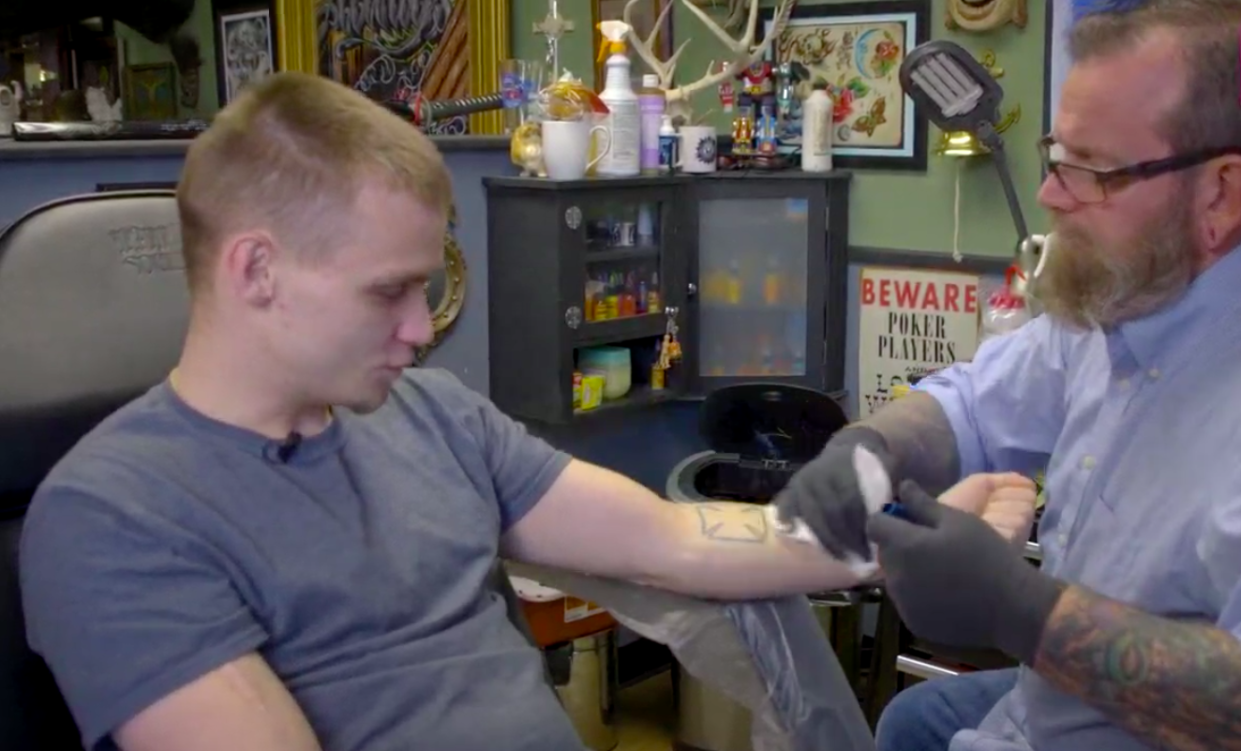 David Cutlip covers up a Nazi-related tattoo for a man who no longer feels the symbol represents his belief system. “I’m not a skinhead anymore.” (Photo: Courtesy of ABC 10)