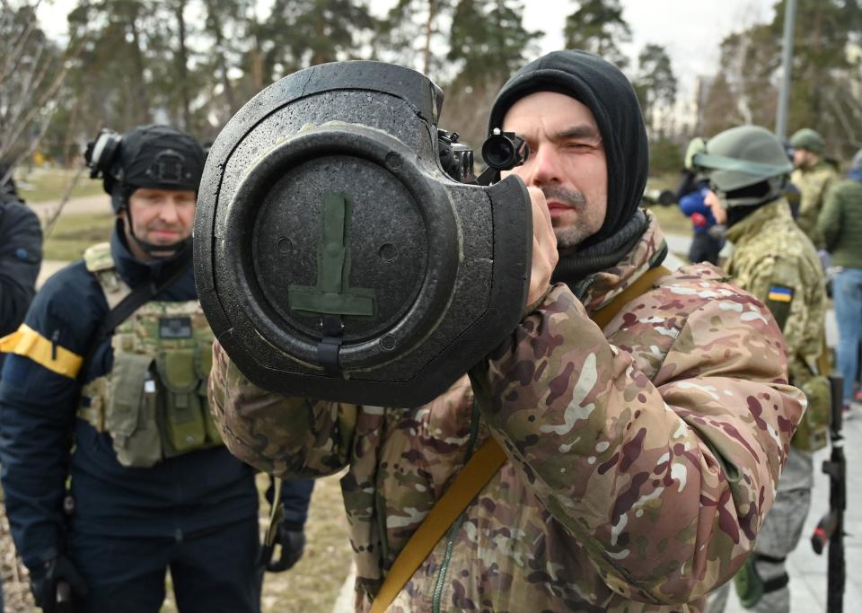 A member of the Ukrainian Territorial Defense Forces looks through the sight of an armament.