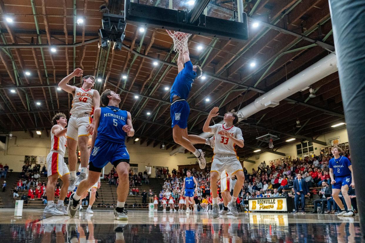 Memorial’s Tucker Tornatta (35) dunks the ball as the Memorial Tigers play the Mater Dei Wildcats during the 2024 IHSAA Class 3A Boys Basketball Sectional 32 semifinals at Boonville High School Friday, March 1, 2024.