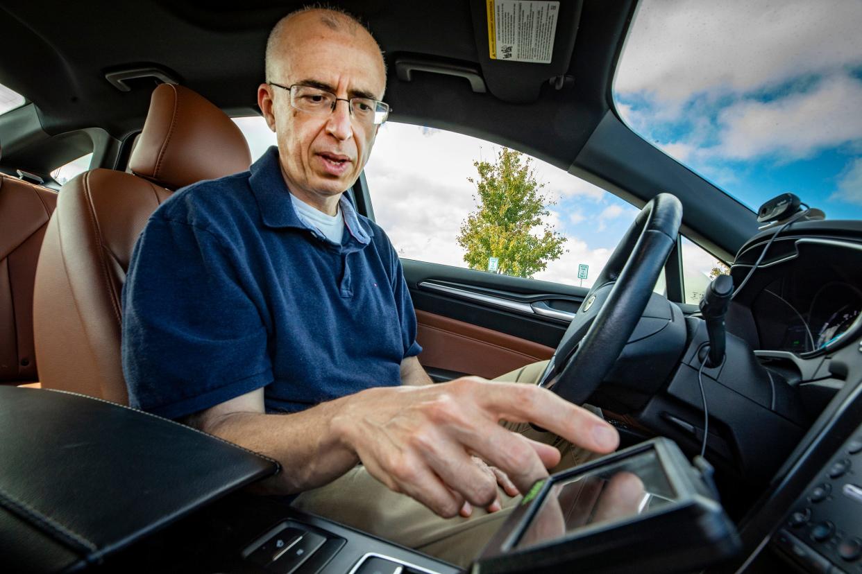 Onur Toker, an associate professor at Florida Polytechnic University in the Department of Electrical and Computer Engineering, sits inside the autonomous Ford Fusion sedan the school recently received. Researchers at Florida Poly's Advanced Mobility Institute are beginning a new phase in their work on autonomous vehicle testing and verification.