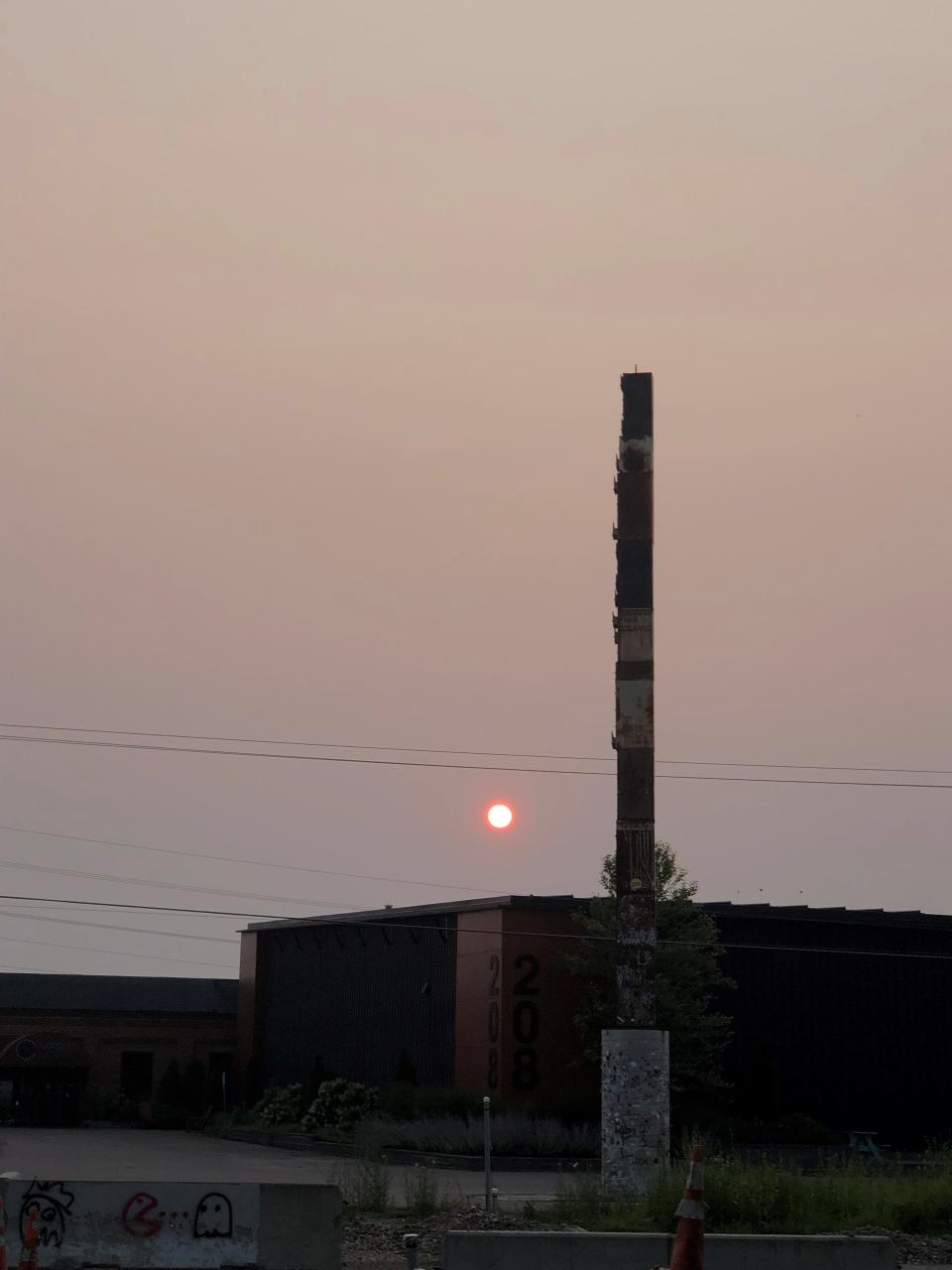 The World's Tallest Filing Cabinet is silhouetted against the red setting sun shining through smoke from Canadian wildfires on Monday, July 17, 2023,  in Burlington, Vt.