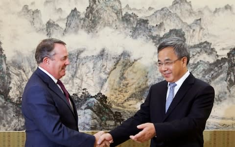 British Secretary of State for International Trade Liam Fox, left, meets Chinese Vice Premier Hu Chunhua at the Zhongnanhai Leadership Compound in Beijing last month - Credit: Reuters