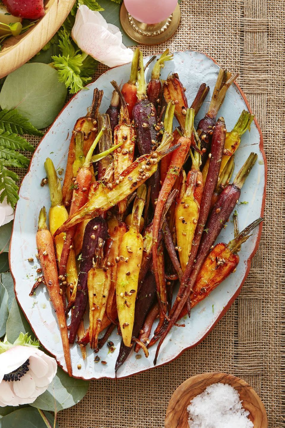 coriander maple glazed carrots on an ovan serving dish on a burlap table cloth