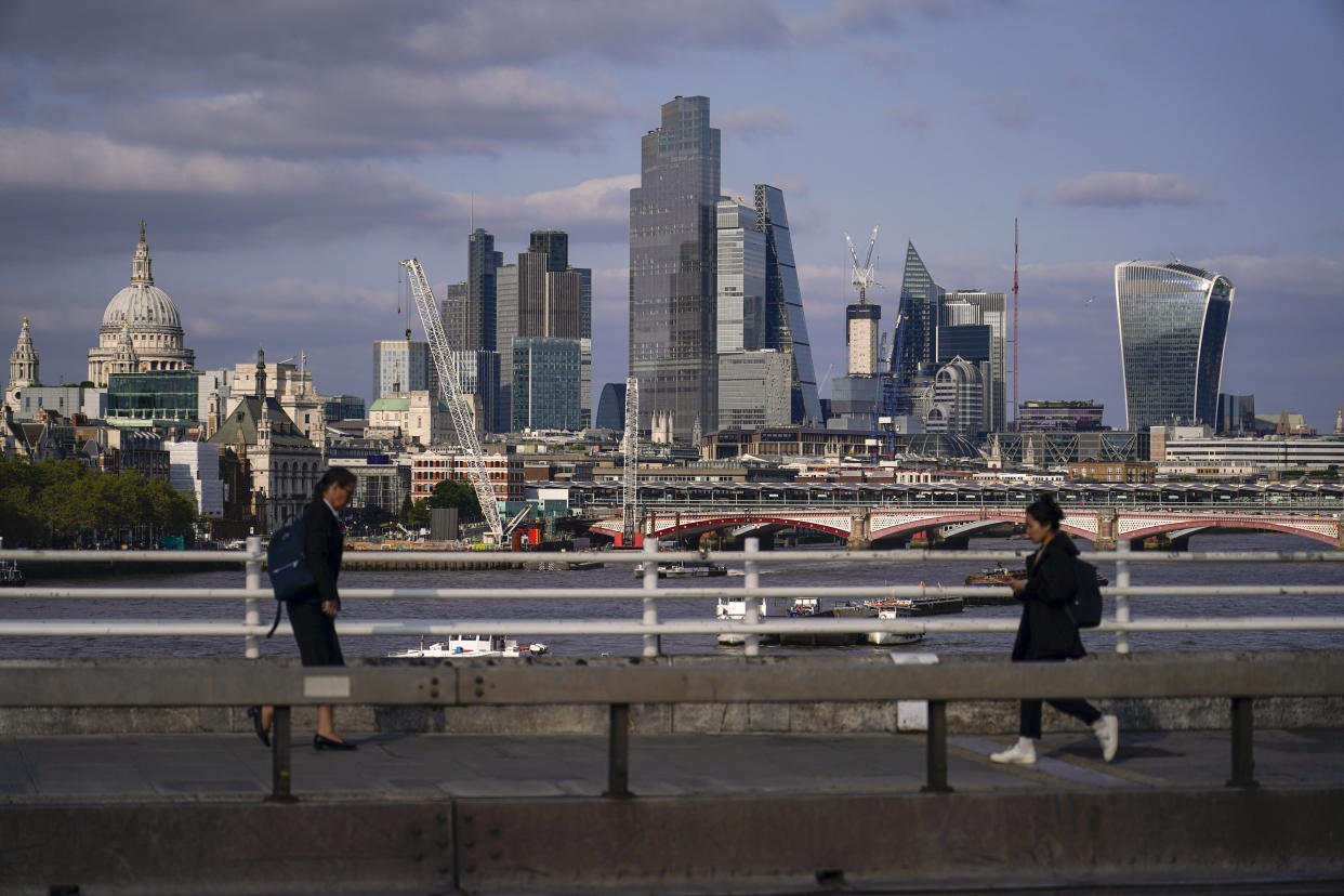 FTSE: Commuters walk along Waterloo Bridge in London.