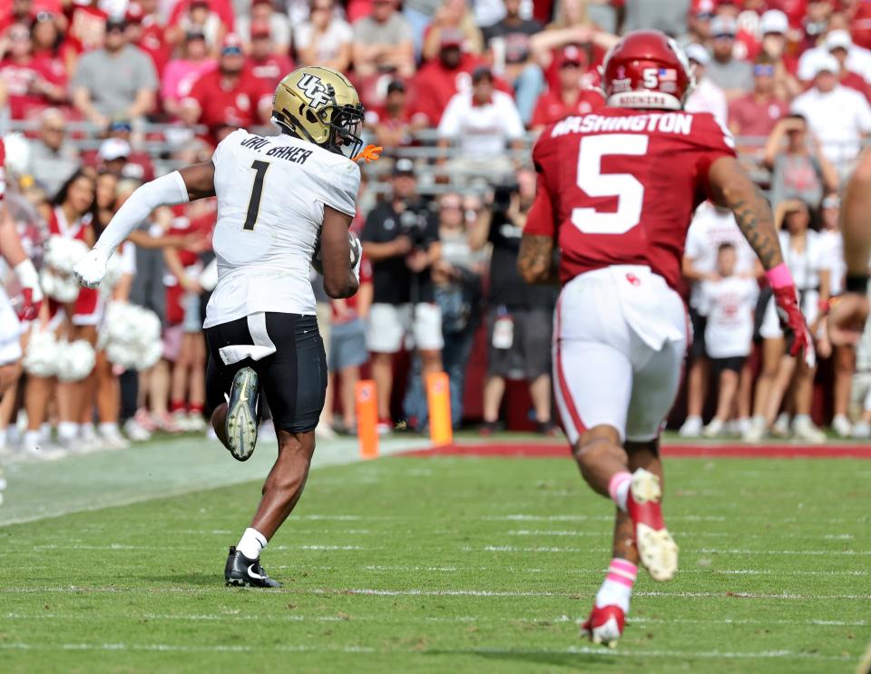UCF's Javon Baker (1) runs for a touchdown after an reception as Oklahoma's Woodi Washington (5) chases him in the first half of the college football game between the University of Oklahoma Sooners and the University of Central Florida Knights at Gaylord Family Oklahoma-Memorial Stadium in Norman, Okla., Saturday, Oct., 21, 2023.