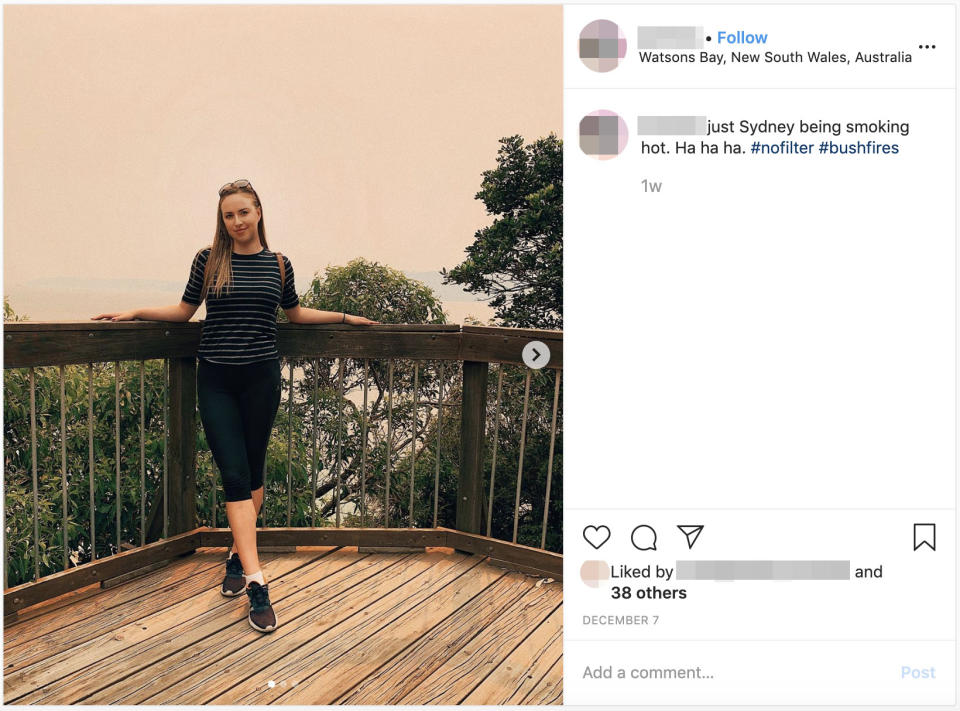 Pictured is a woman posing in Sydney in front of bushfire smoke haze.