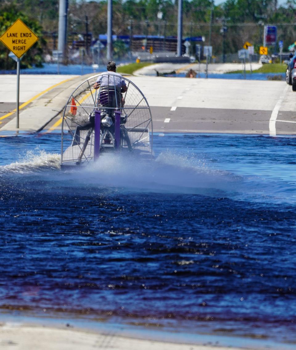 An airboat captain evacuates people from flooded areas of DeSoto County, Florida, on Sunday, Oct. 2, 2022, following the passage of Hurricane Ian.