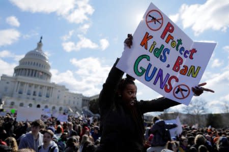 FILE PHOTO: Washington, DC High School student Sara Durbin joins with other students walking out of classes to demand stricter gun laws outside the U.S. Capitol in Washington, U.S.,  March 14, 2018. REUTERS/Jim Bourg