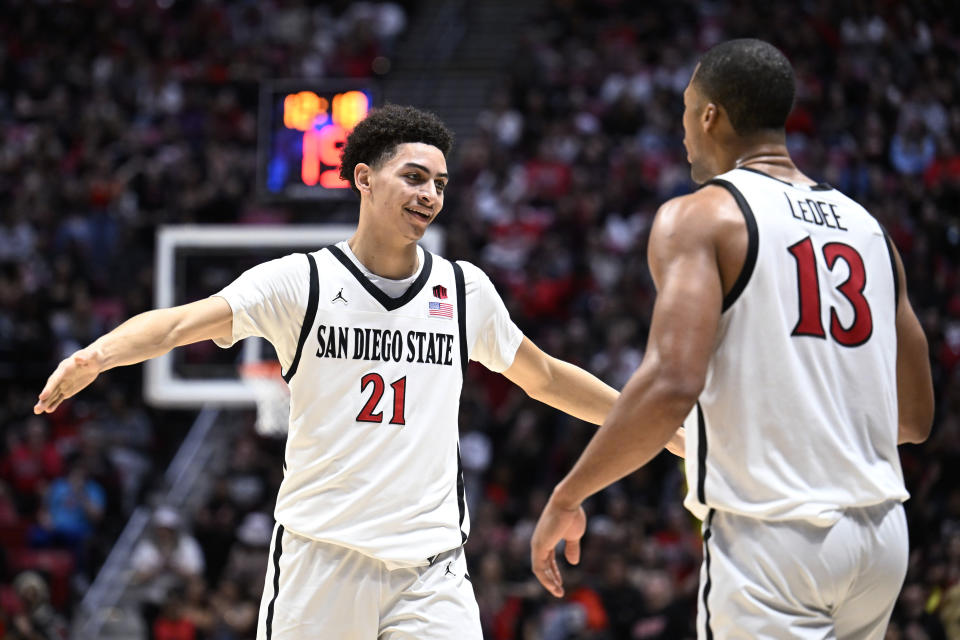 San Diego State forward Jaedon LeDee (13) celebrates with Miles Byrd (21) after LeDee scored against San Jose State during the second half of an NCAA college basketball game Tuesday, Feb. 27, 2024, in San Diego. (AP Photo/Denis Poroy)